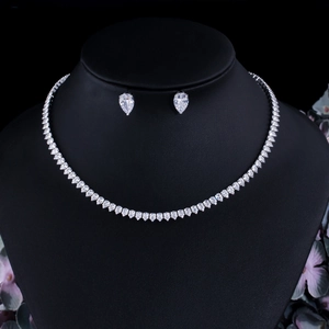 Silver bridal jewelry set with white zircon necklace and drop earrings on black velvet