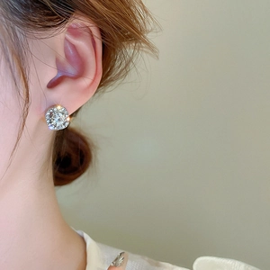 Detailed view of silver square geometric stud earrings with sparkling pave-set zircons