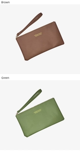 Close-up of brown and green long slim wallets with wrist straps and golden lettering