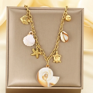 Golden ocean theme necklace with starfish sea turtle and shell charms on silk