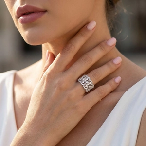 Elegant wide lace sterling silver ring with micro-paved moissanite on female finger
