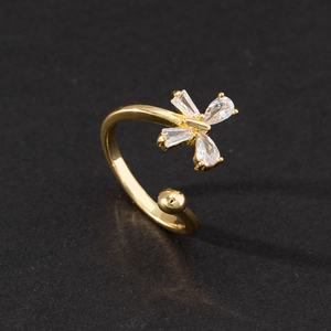 Detail shot of open gold ring featuring two pear and two rectangular cut zircon stones