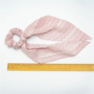 Pink fabric hair scrunchie with long ribbon streamers, 32cm length shown on white background