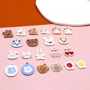 Flat lay of colorful matte animal alloy pendants featuring cute bears and bunnies