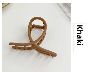 Detail of khaki matte finish hair claw clip with crossed loop streamline design
