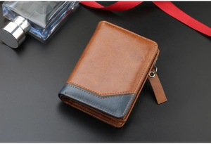 Detail of brown and blue leather bifold wallet texture with perfume and red ribbon