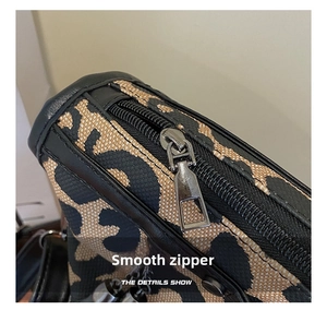 Close-up of leopard print handbag showing smooth black zipper and silver metal hardware