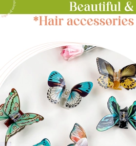 Detailed view of colorful butterfly hair claws with elegant textures and gold springs