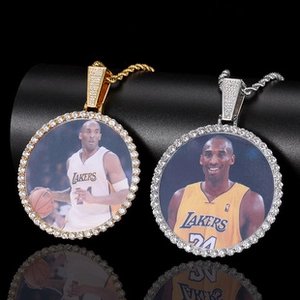 Macro detail of gold and silver cross pendants with micro-pave stones and sports jersey motif