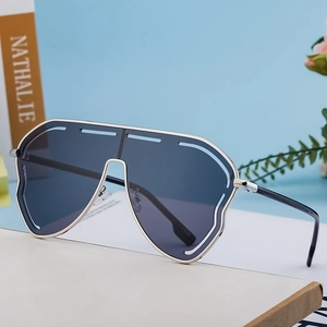 Fashion oversized silver metal frame sunglasses with grey lenses on minimalist background