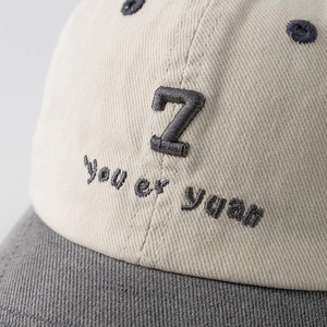 Toddler cotton baseball cap with number 7 embroidery and gray brim on cream crown