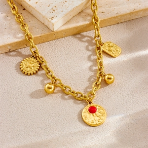 Retro gold stainless steel sun pendant necklace with charms on textured stone background
