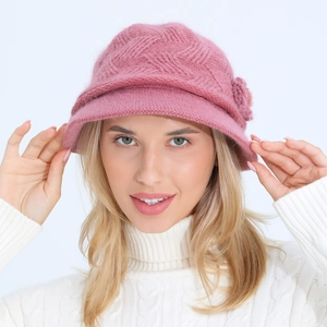Detail of rose pink winter knit hat with floral accent and warm plush wool texture