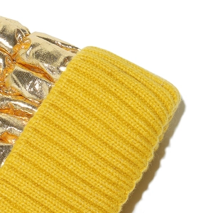 Detail of yellow ribbed knit fabric joined with shiny gold metallic coated material