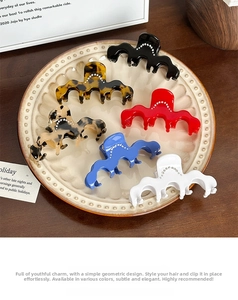 Detail of medium-sized wavy acetate hair claws in six colors with sparkling rhinestones