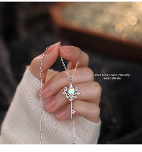 Detail of S925 silver key necklace featuring a heart-shaped opal and sparkling zircons