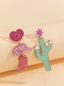 Detail of glitter Western earrings with pink cowboy hat, boots, and cactus charms