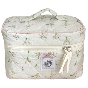 Quilted floral makeup bag with elephant label, bow details and top handle in off-white