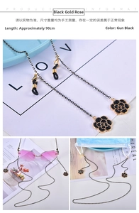 Detail of 90cm gun black glasses chain with black and gold enamel rose pendants