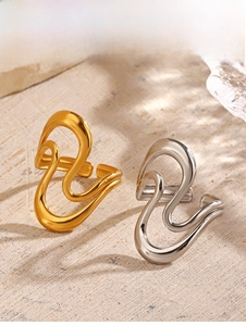 Macro detail of abstract wavy 18K gold and silver plated stainless steel rings