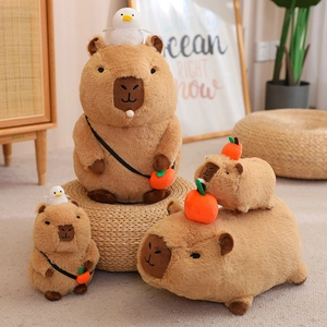 Cute brown capybara plush toy with orange citrus accessory and tiny white bird on top