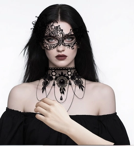 Macro view of gothic black lace necklace with oval gemstone and dangling metal tassels