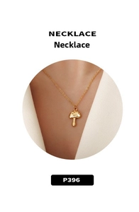 Detailed view of mushroom-shaped gold pendant necklace with handcrafted hammered texture