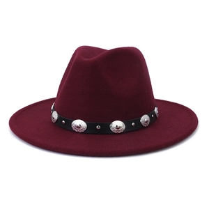 Detailed close-up of wine red fedora hat with black belt and silver metal accents