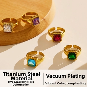 Macro shot of colorful zircon stones on gold-plated stainless steel rings displayed on wood