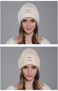 Detail of soft rabbit fur knit beanie showing vertical ribbing and SEASON 12 patch