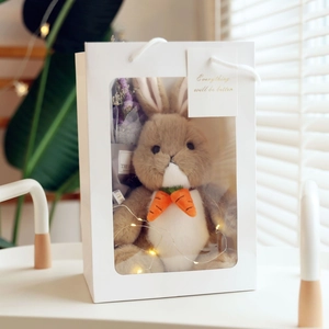 Cute bunny plush toy in a white gift box with LED lights and a dried flower bouquet