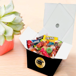 Detail of a graduation candy box with a gold sticker and mixed assorted sweets