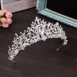 Close-up of silver tiara with white crystals and large teardrop centerpiece diamond