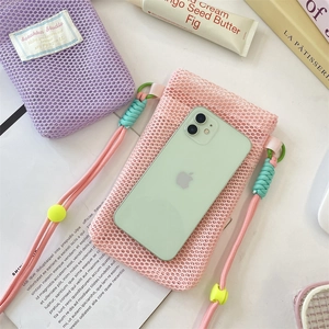 Detail of mesh phone pouch with woven strap and vibrant dopamine color scheme