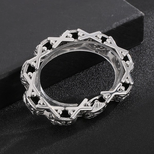 Retro stainless steel X-shaped cross bracelet with floral engravings on dark texture