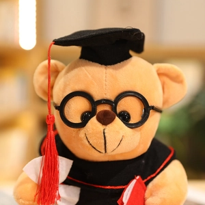 Detailed close-up of a graduation teddy bear plush wearing a gown and round glasses