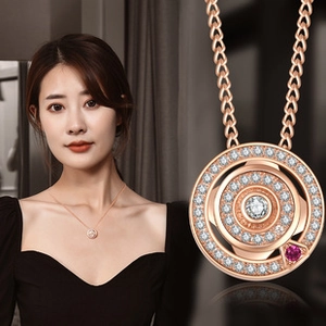 Detail of rose gold clover necklace with crystal inlay and heart shape conversion