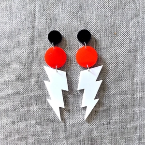 Retro acrylic lightning bolt drop earrings in neon black, red and white geometric design