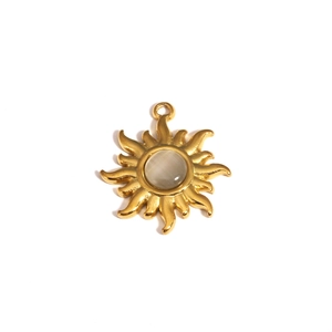 Detail of vintage golden sun pendant with teardrop opal stone and sparkling diamonds