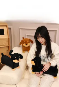 Close-up of soft plush dachshund dog toy in brown and black colors for kids