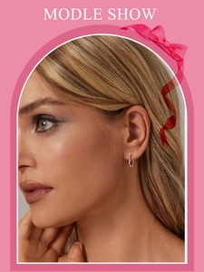 Close-up of model wearing pink enamel heart hoop earrings in s925 sterling silver