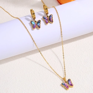 Macro shot of butterfly jewelry set with iridescent gemstones and gold finish