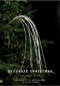 Macro van een 90cm witte glitter lovertjes tak hangend aan een versierde kerstboom
