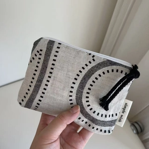 Macro shot of minimalist denim canvas pouch with geometric print and simple wish label