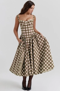 Detail of green plaid sun dress featuring a corset waist, side pockets, and a full skirt