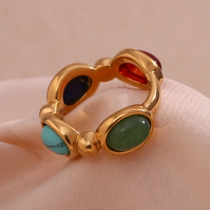 Anello placcato oro 18K con pietre naturali ovali colorate su tessuto beige morbido