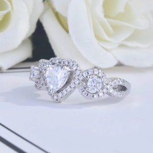 Macro detail of silver heart ring featuring sparkling pavé crystals and polished band