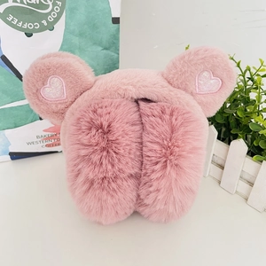 Detail of pink plush earmuffs showing soft texture and sparkly heart sequins embroidery