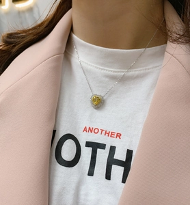 Close-up of heart-shaped yellow diamond pendant necklace on model with 925 silver chain