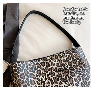 Close-up of leopard print shoulder bag with detailed stitching and durable black handle